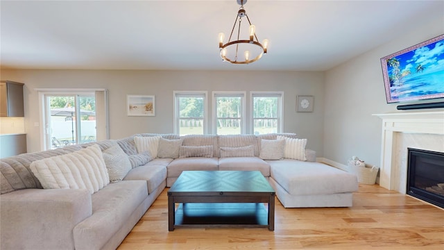 9 Shaw Ln, East Moriches, NY 11940 - living area featuring a chandelier, light wood-type flooring, and a high end fireplace