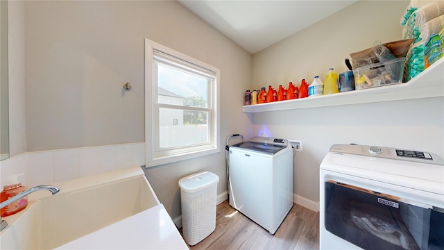 9 Shaw Ln, East Moriches, NY 11940 - laundry area with light wood-type flooring and separate washer and dryer