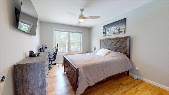9 Shaw Ln, East Moriches, NY 11940 - bedroom with a desk, light wood-style flooring, and a ceiling fan
