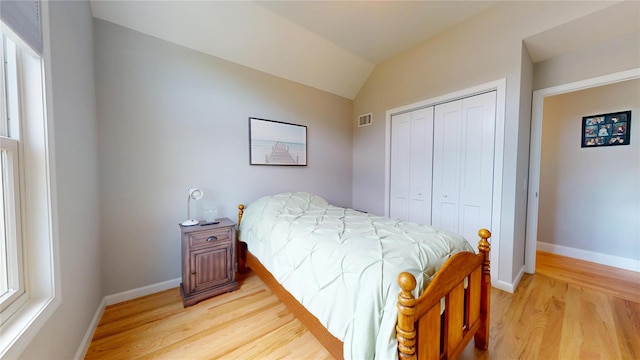 9 Shaw Ln, East Moriches, NY 11940 - bedroom featuring light wood-style floors, a closet, and lofted ceiling