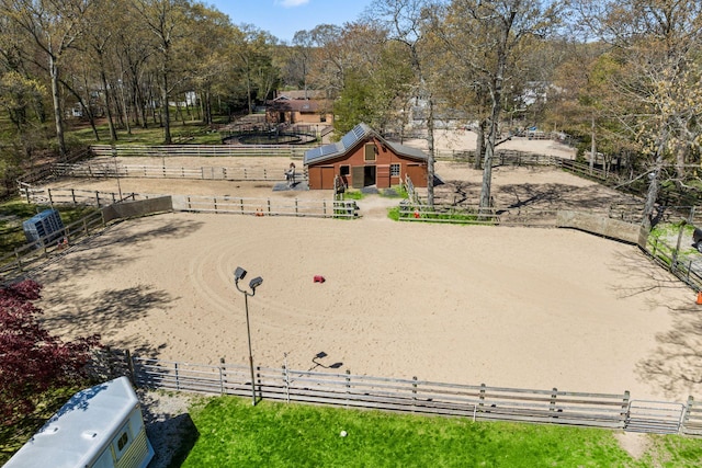 24 Croft Ln, Smithtown, NY 11787 - view of community with an outdoor riding arena, view of wooded area, and an exterior structure
