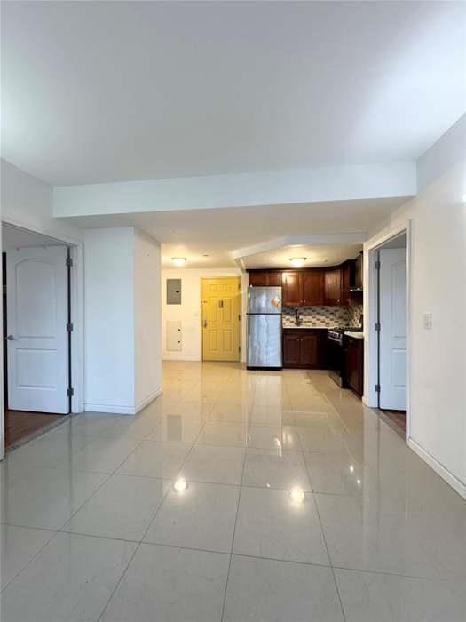 7166 Parsons Blvd Unit 6E, Fresh Meadows, NY 11365 - kitchen with freestanding refrigerator, tasteful backsplash, stove, and light tile patterned floors