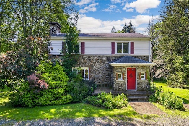 1095 State Route 94, New Windsor, NY 12553 - view of front of home with stone siding, a front lawn, and a chimney