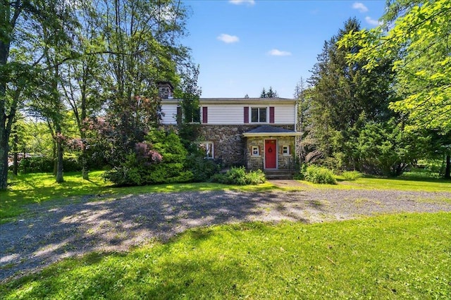 1095 State Route 94, New Windsor, NY 12553 - view of front of house featuring stone siding, a front yard, and a chimney