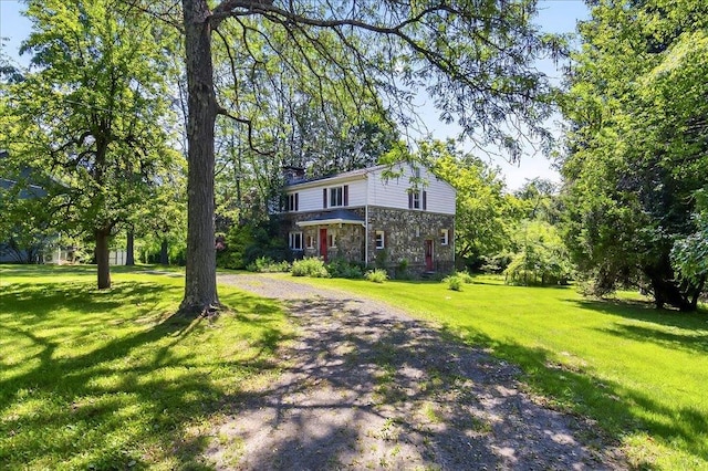 1095 State Route 94, New Windsor, NY 12553 - view of front facade featuring driveway, stone siding, and a front yard