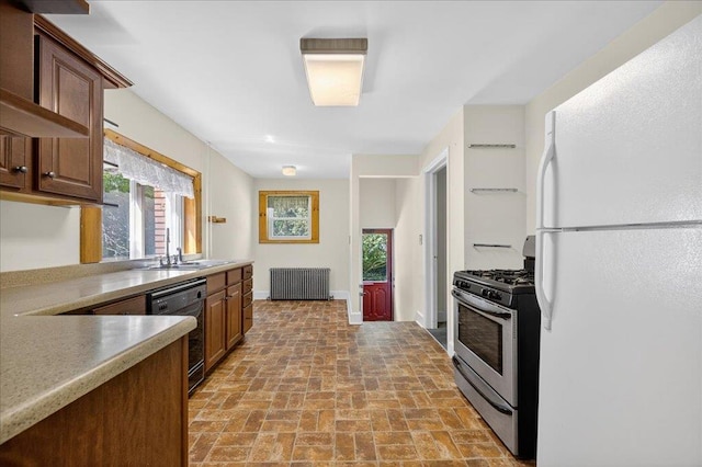 1095 State Route 94, New Windsor, NY 12553 - kitchen with freestanding refrigerator, black dishwasher, stainless steel gas range oven, radiator, and light countertops