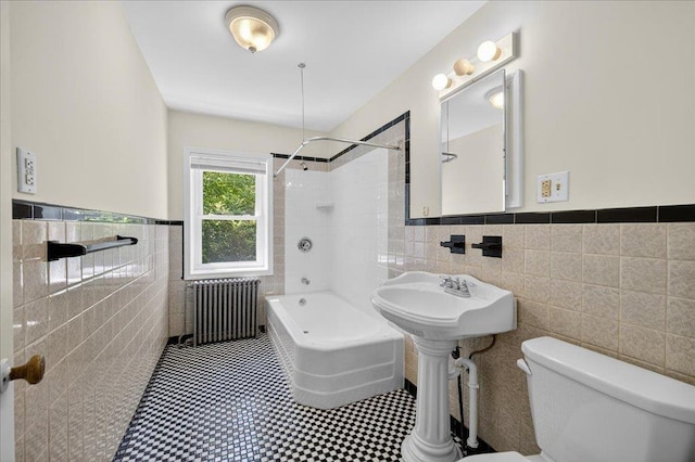 1095 State Route 94, New Windsor, NY 12553 - bathroom featuring radiator, tile walls, tub / shower combination, a wainscoted wall, and tile patterned flooring