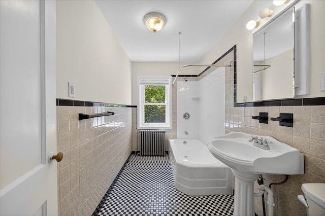 1095 State Route 94, New Windsor, NY 12553 - bathroom featuring tile walls, radiator heating unit, shower / bath combination, a wainscoted wall, and tile patterned flooring