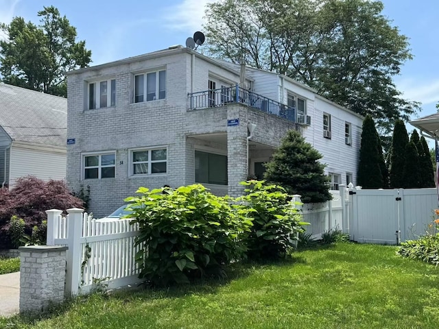 38 Nesaquake Ave, Port Washington, NY 11050 - view of front of house featuring a balcony, cooling unit, and brick siding