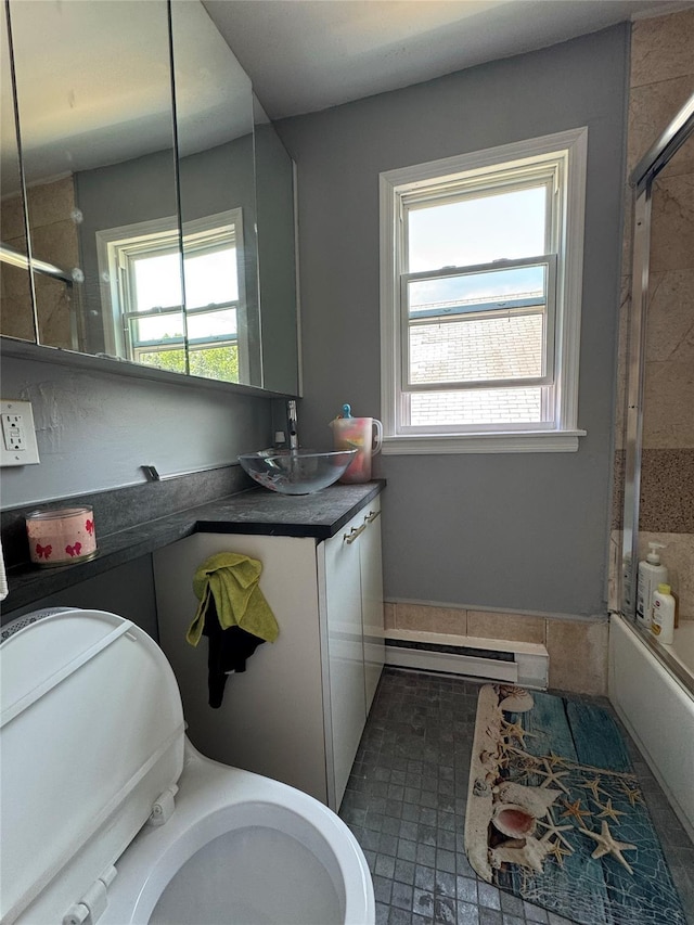 38 Nesaquake Ave, Port Washington, NY 11050 - bathroom with baseboard heating, healthy amount of natural light, combined bath / shower with glass door, and vanity