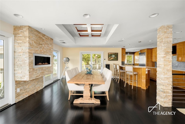 50 Ships Point Ln, Oyster Bay, NY 11771 - dining space with dark wood-style floors, ornate columns, recessed lighting, a stone fireplace, and coffered ceiling