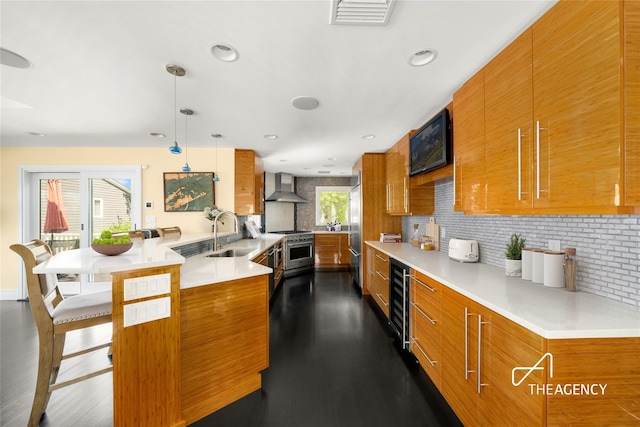 50 Ships Point Ln, Oyster Bay, NY 11771 - kitchen with brown cabinetry, wall chimney range hood, high end appliances, decorative backsplash, and a kitchen breakfast bar