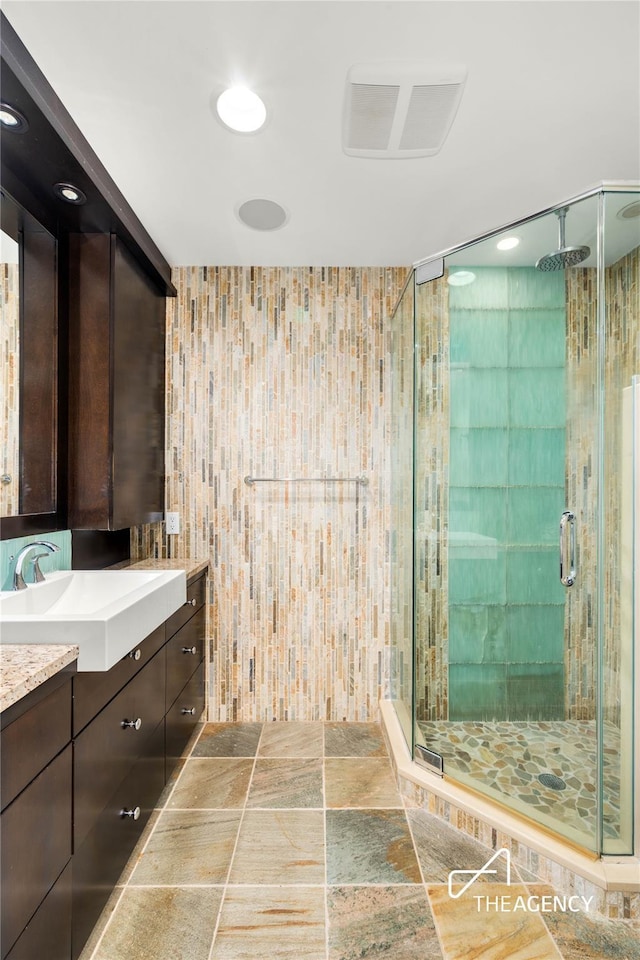 50 Ships Point Ln, Oyster Bay, NY 11771 - full bath with vanity, a shower stall, tile walls, and stone finish flooring