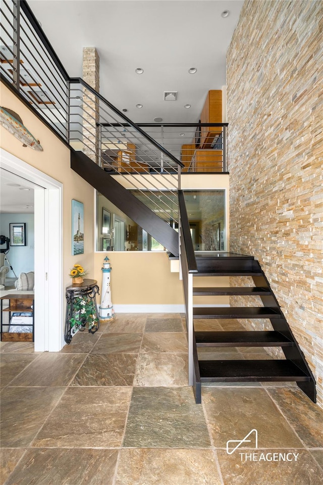50 Ships Point Ln, Oyster Bay, NY 11771 - stairway with stone tile floors, a high ceiling, and recessed lighting