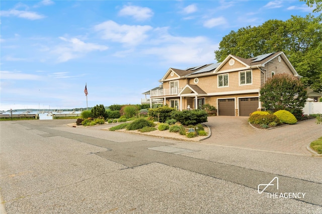 50 Ships Point Ln, Oyster Bay, NY 11771 - view of front of house featuring a garage, solar panels, a balcony, and decorative driveway