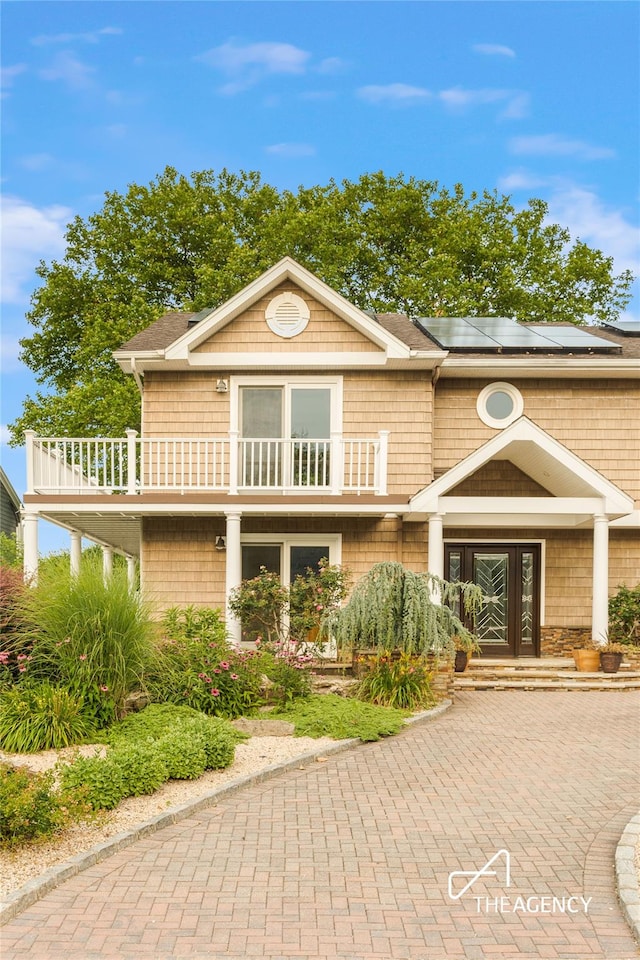50 Ships Point Ln, Oyster Bay, NY 11771 - view of front of house featuring a balcony, solar panels, and french doors