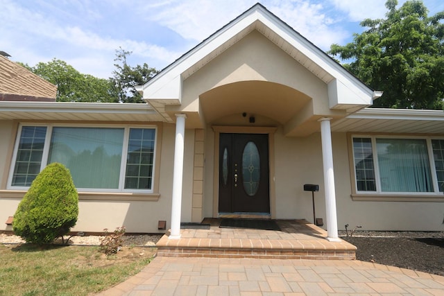 148 Spruce St, Lindenhurst, NY 11757 - doorway to property with stucco siding