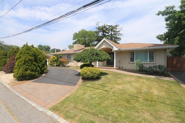 148 Spruce St, Lindenhurst, NY 11757 - view of front of home with stucco siding and asphalt driveway