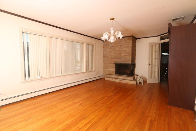 148 Spruce St, Lindenhurst, NY 11757 - unfurnished living room featuring a chandelier, wood-type flooring, crown molding, baseboard heating, and a stone fireplace