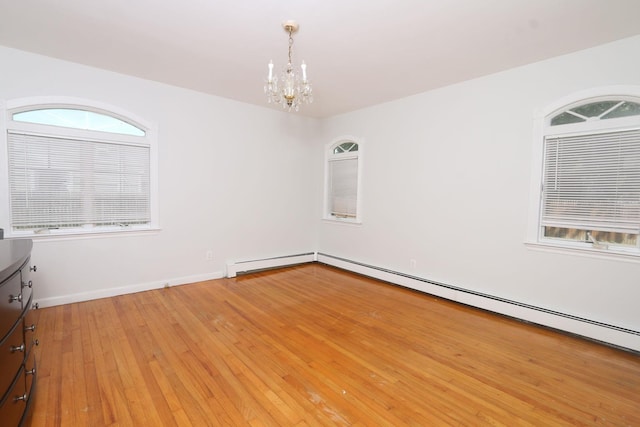 148 Spruce St, Lindenhurst, NY 11757 - unfurnished room with a chandelier, light wood-type flooring, and baseboard heating