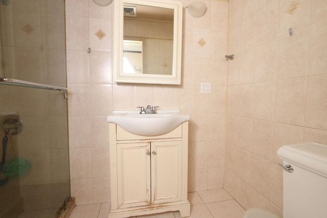 148 Spruce St, Lindenhurst, NY 11757 - bathroom featuring tile walls, a stall shower, vanity, and tile patterned floors