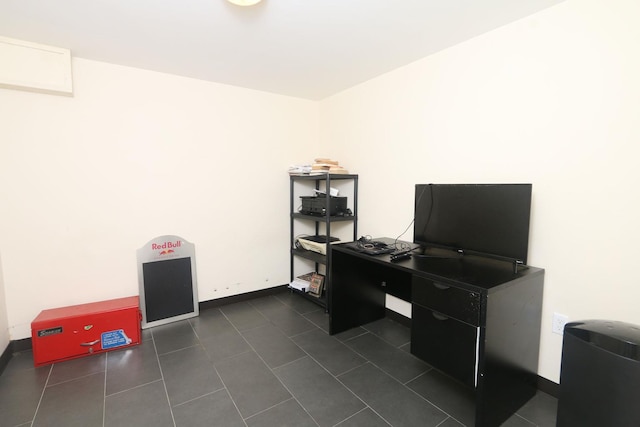 148 Spruce St, Lindenhurst, NY 11757 - office area featuring dark tile patterned flooring and baseboards