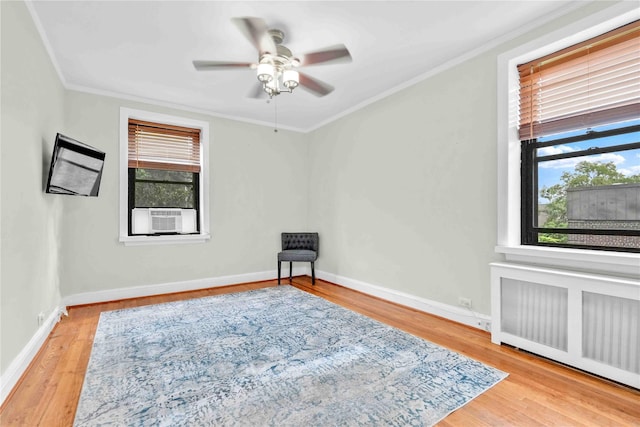 21-40 78th St Unit 2, East Elmhurst, NY 11370 - spare room featuring radiator, plenty of natural light, wood finished floors, crown molding, and cooling unit