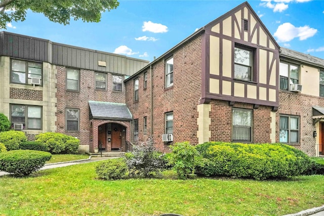 21-40 78th St Unit 2, East Elmhurst, NY 11370 - view of front facade with brick siding, a front yard, and cooling unit