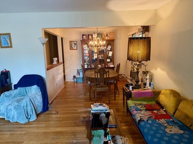 216 Hill Ave, Elmont, NY 11003 - dining room featuring a chandelier and wood finished floors