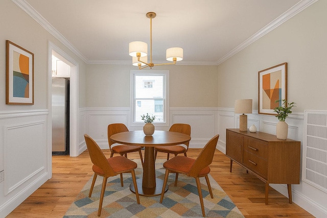 176 Hillsboro Ave, Elmont, NY 11003 - dining room with light wood finished floors, crown molding, and a wainscoted wall