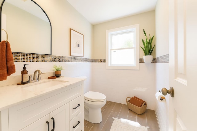 176 Hillsboro Ave, Elmont, NY 11003 - bathroom with tile walls, vanity, a wainscoted wall, and wood finished floors