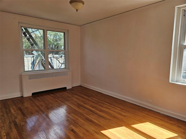 7215 37th Ave Unit 3H, Jackson Heights, NY 11372 - spare room with radiator heating unit and wood finished floors