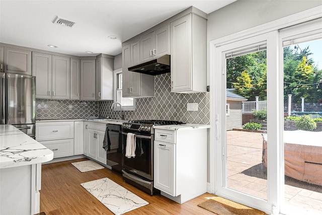 3 Grant Ave, Albertson, NY 11507 - kitchen with stainless steel appliances, under cabinet range hood, gray cabinetry, wood finished floors, and recessed lighting