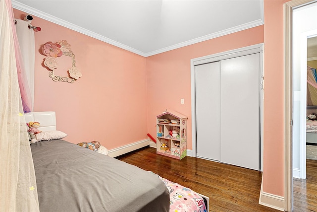 3 Grant Ave, Albertson, NY 11507 - bedroom with a baseboard heating unit, wood finished floors, crown molding, and a closet