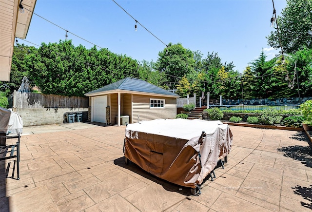 3 Grant Ave, Albertson, NY 11507 - view of patio / terrace with an outdoor structure, a jacuzzi, and a garage