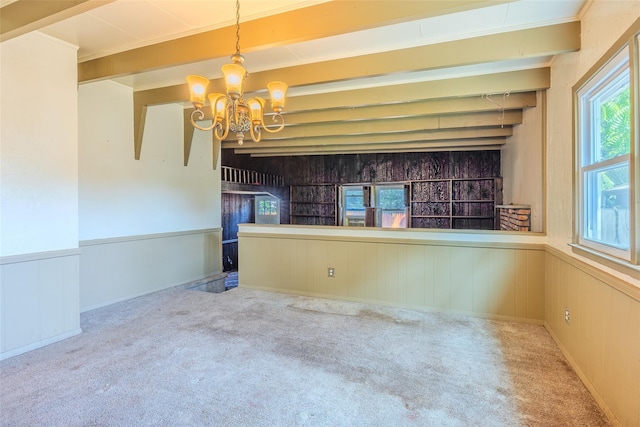 12 Rivera Ln, West Sayville, NY 11796 - unfurnished dining area with a chandelier, a wainscoted wall, carpet floors, and wood walls