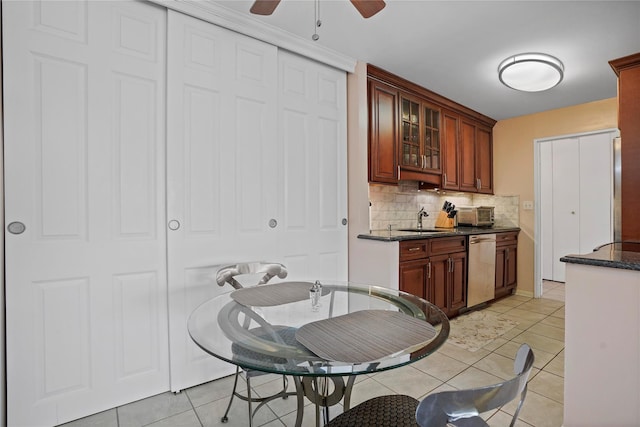 100 High Point Dr Unit 310, Hartsdale, NY 10530 - kitchen with stainless steel dishwasher, ceiling fan, tasteful backsplash, light tile patterned floors, and glass insert cabinets
