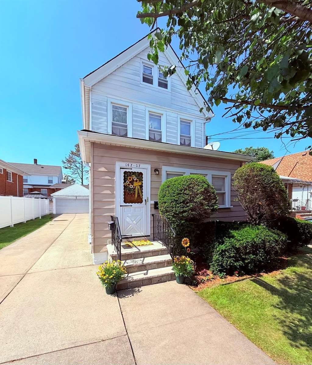 14707 15th Ave, Whitestone, NY 11357 - view of front facade featuring an outdoor structure and a garage