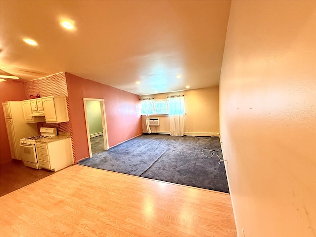 18 Ivy St Unit 1B, Farmingdale, NY 11735 - unfurnished living room with dark wood-style flooring, baseboard heating, and recessed lighting