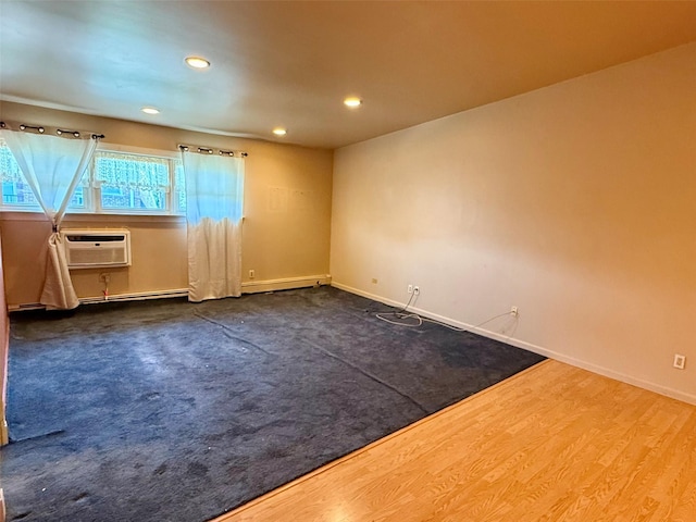 18 Ivy St Unit 1B, Farmingdale, NY 11735 - unfurnished room with recessed lighting, baseboard heating, an AC wall unit, and wood finished floors