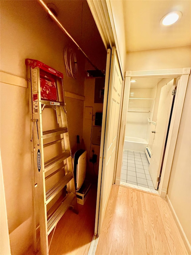 18 Ivy St Unit 1B, Farmingdale, NY 11735 - corridor with wood finished floors and a baseboard heating unit