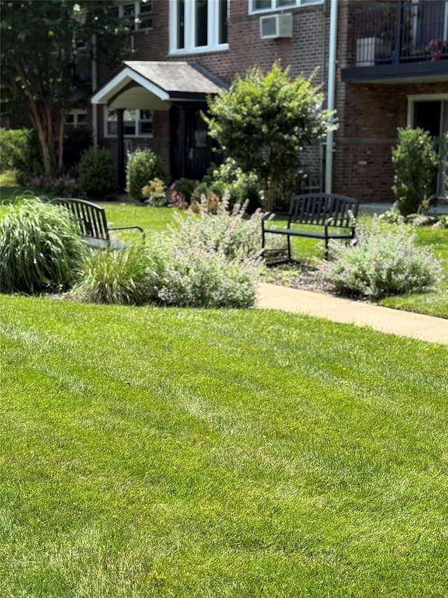 18 Ivy St Unit 1B, Farmingdale, NY 11735 - view of green lawn with a balcony and cooling unit