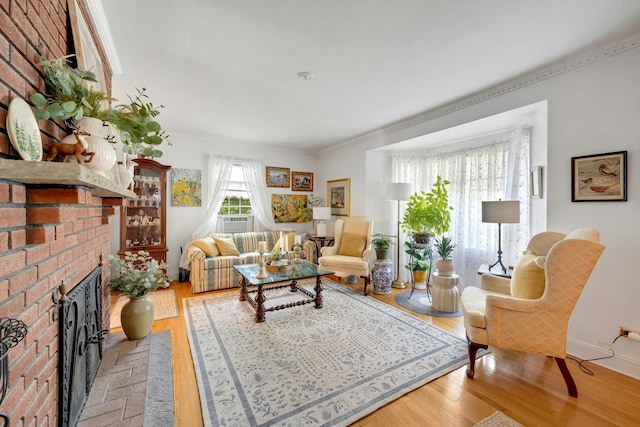 86 Briary Rd, Dobbs Ferry, NY 10522 - living room with a brick fireplace, light wood-style flooring, and crown molding