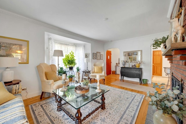 86 Briary Rd, Dobbs Ferry, NY 10522 - living room featuring arched walkways, light wood-type flooring, a fireplace, and ornamental molding