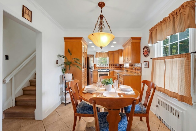 86 Briary Rd, Dobbs Ferry, NY 10522 - dining space featuring radiator heating unit, light tile patterned floors, stairway, and ornamental molding