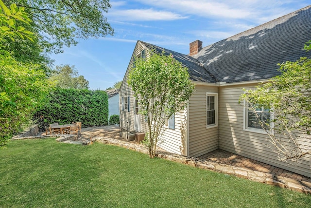 86 Briary Rd, Dobbs Ferry, NY 10522 - view of property exterior featuring a chimney, a yard, a patio, and roof with shingles