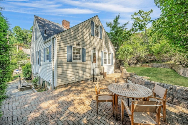 86 Briary Rd, Dobbs Ferry, NY 10522 - back of house with a patio area, a chimney, and outdoor dining space