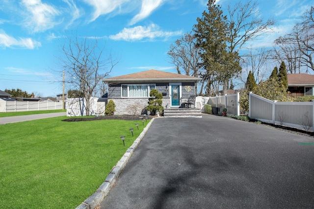 117 E Madison St, East Islip, NY 11730 - bungalow-style house with stone siding and asphalt driveway