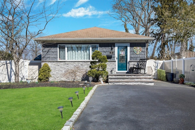 117 E Madison St, East Islip, NY 11730 - view of front of property featuring stone siding and roof with shingles