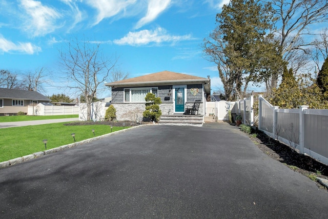 117 E Madison St, East Islip, NY 11730 - bungalow with stone siding and asphalt driveway